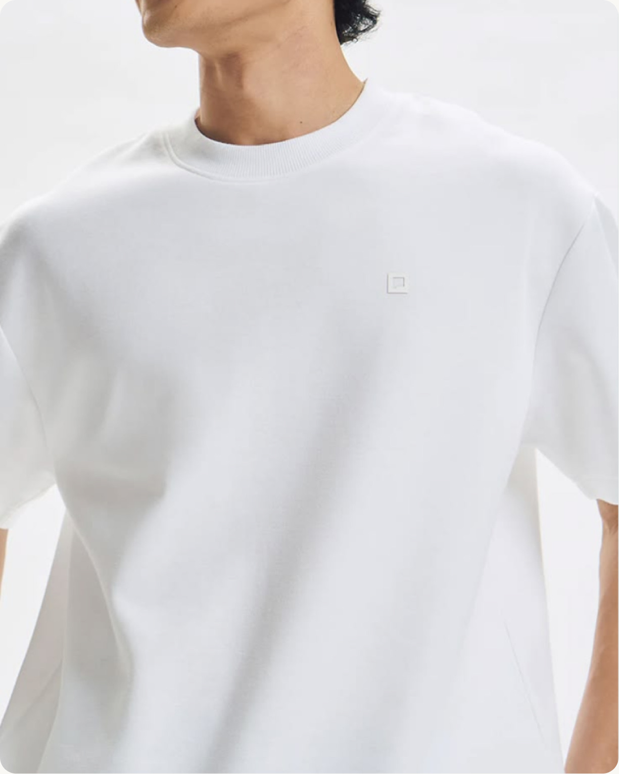 A man wearing a relaxed white T-shirt